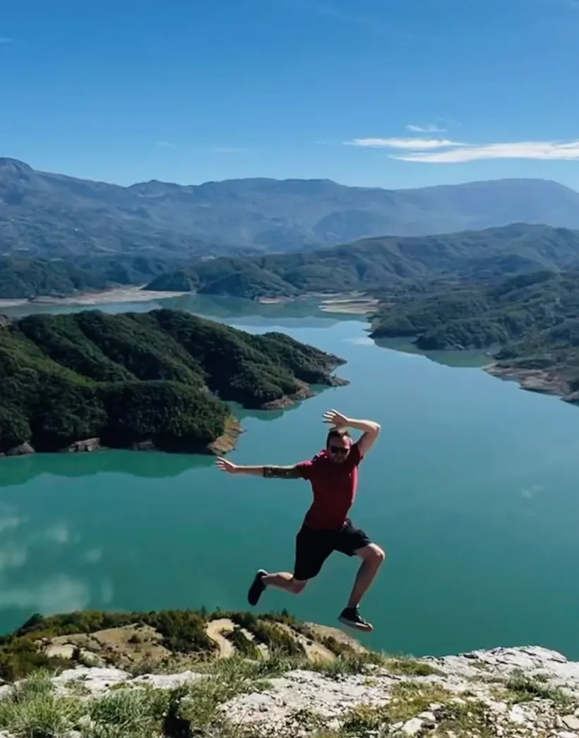 Michael leaping above a mountain lake