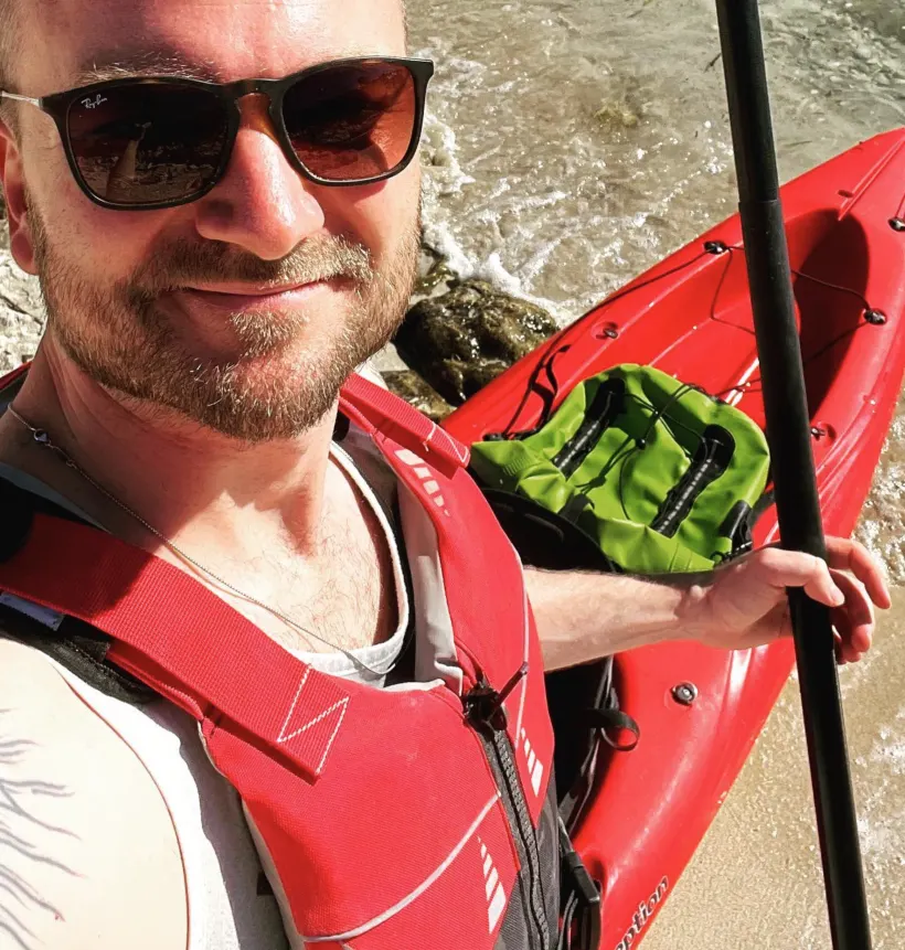 Michael in a kayak holding a paddle