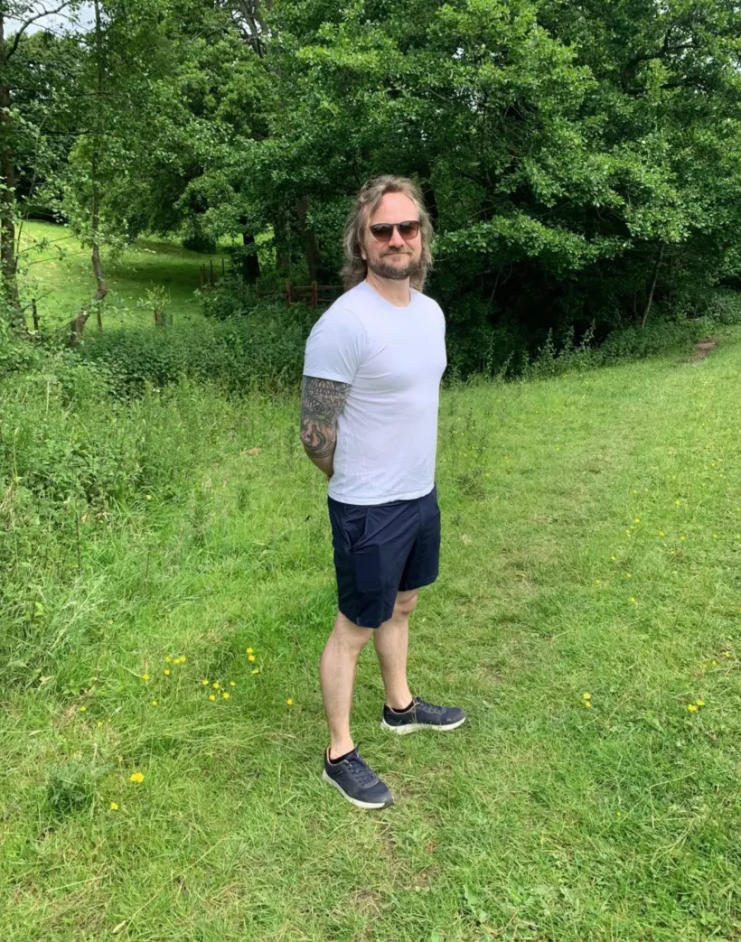 Michael standing in a green field