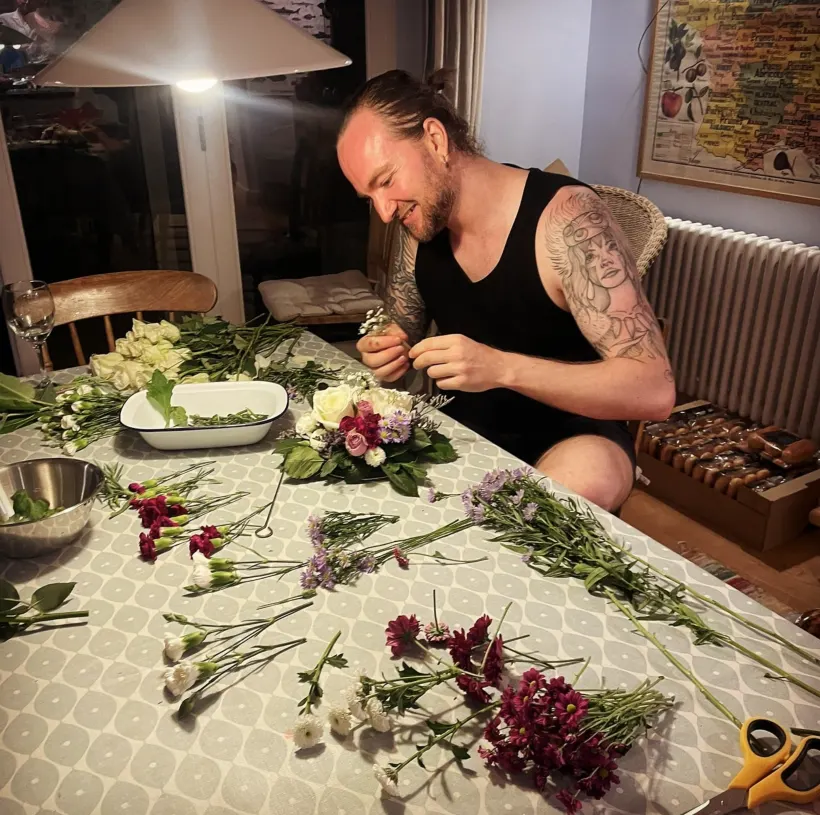 Michael arranging flowers at a table