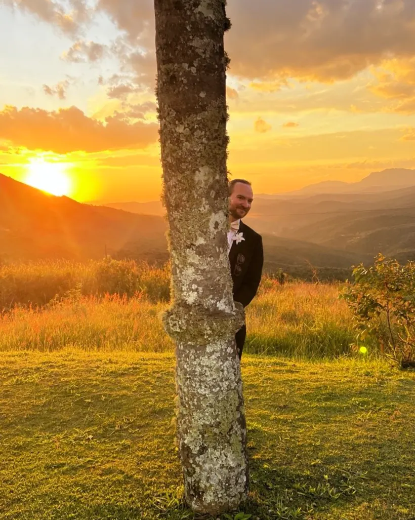 Michael by a tree at sunset over hills