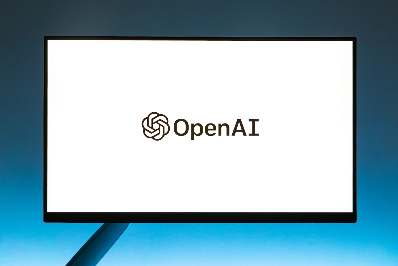 Laptop screen showing an AI assistant interface with a clean chat conversation