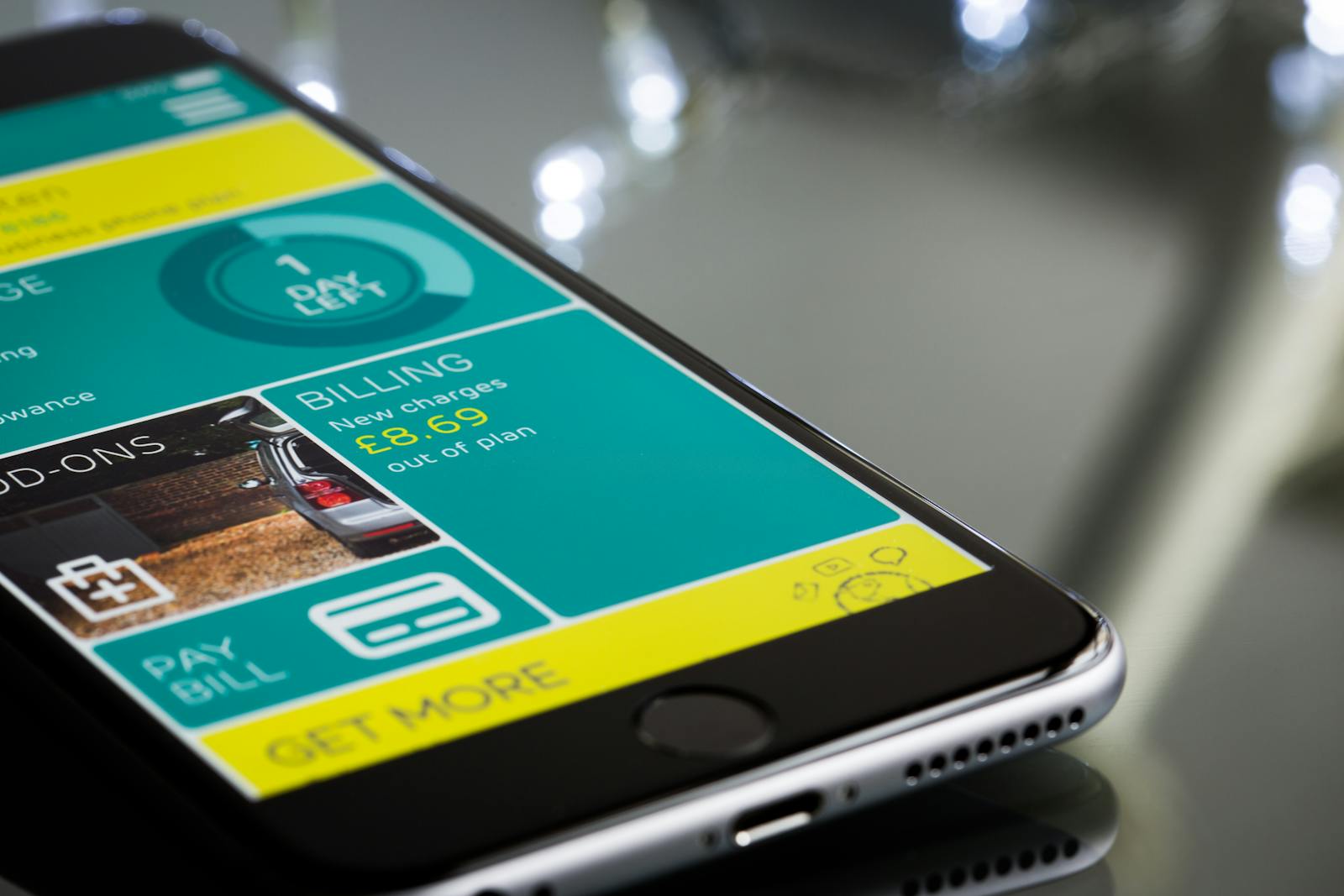 Mobile phone showing a teal and yellow billing screen with a Pay Bill button
