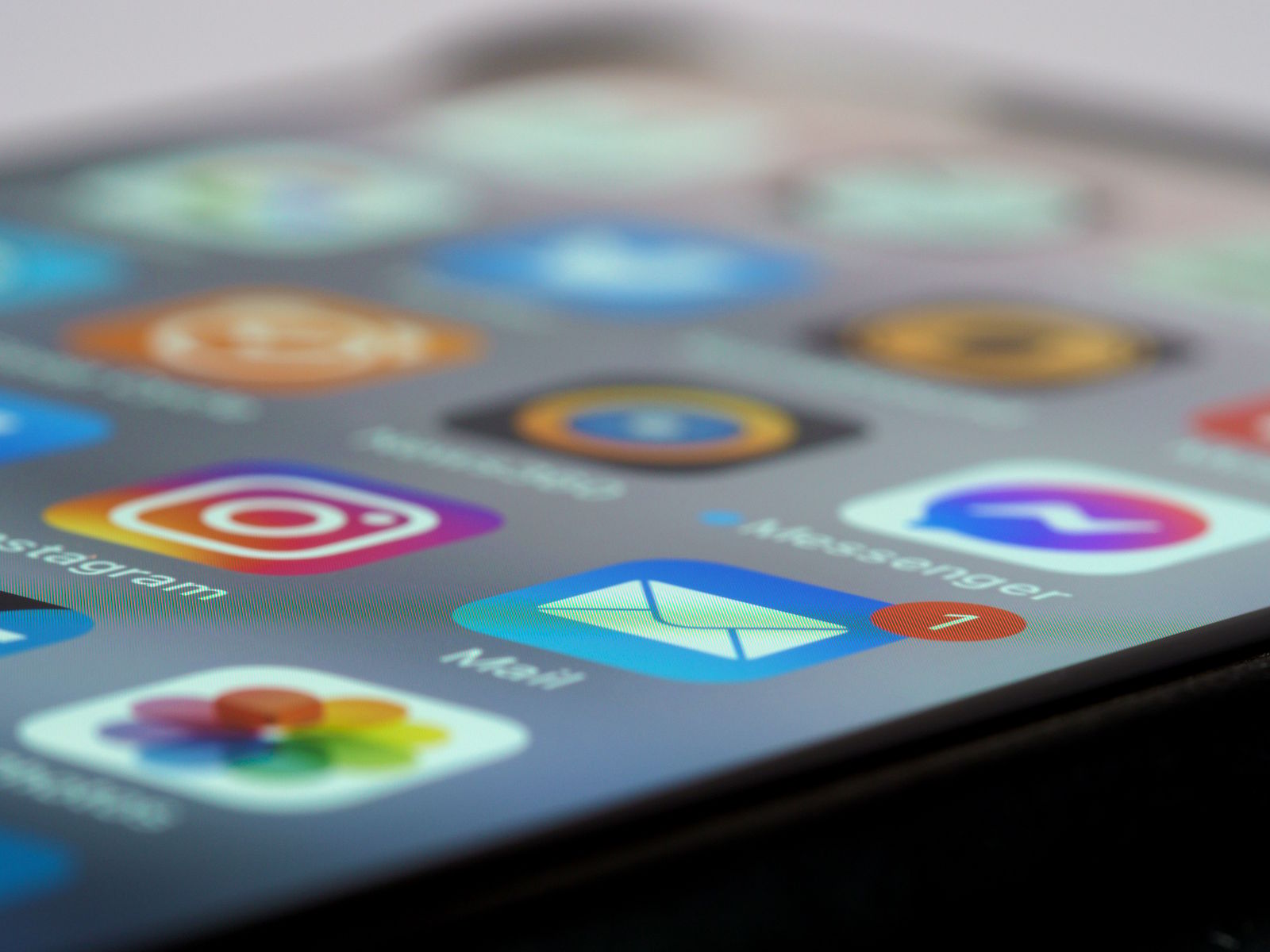 Close-up of a phone screen showing colourful app icons including Instagram, Messenger and Mail