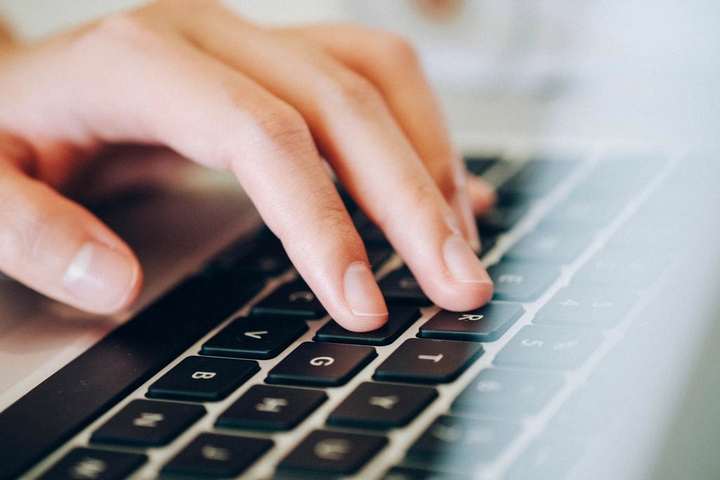 Hands typing on a keyboard