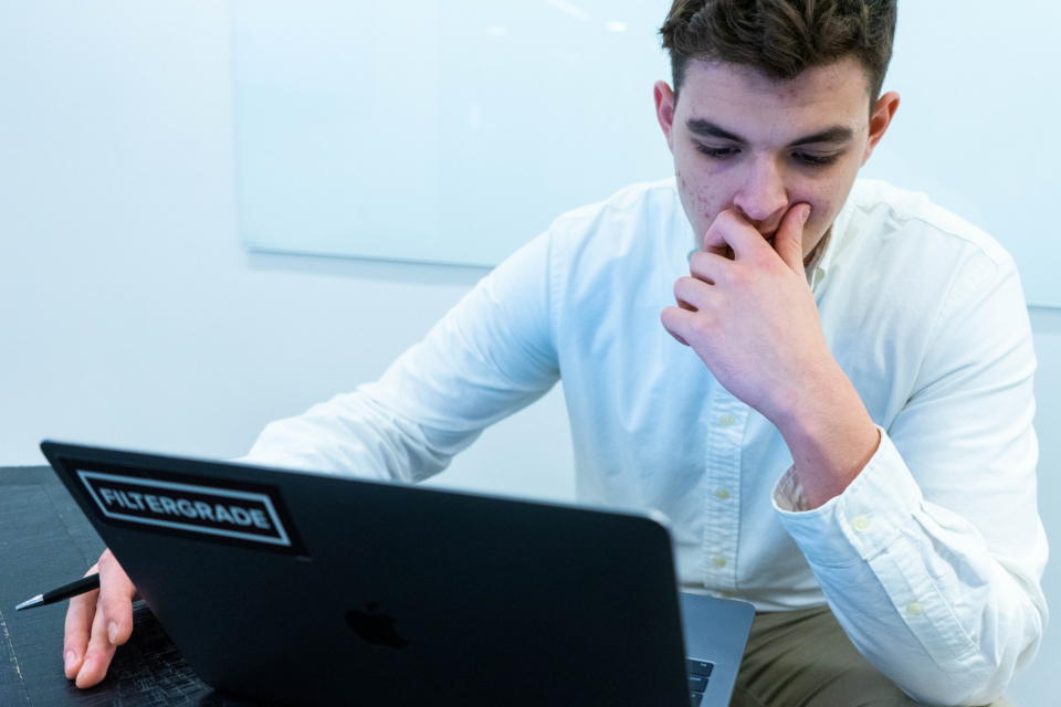 A person thinking at a laptop