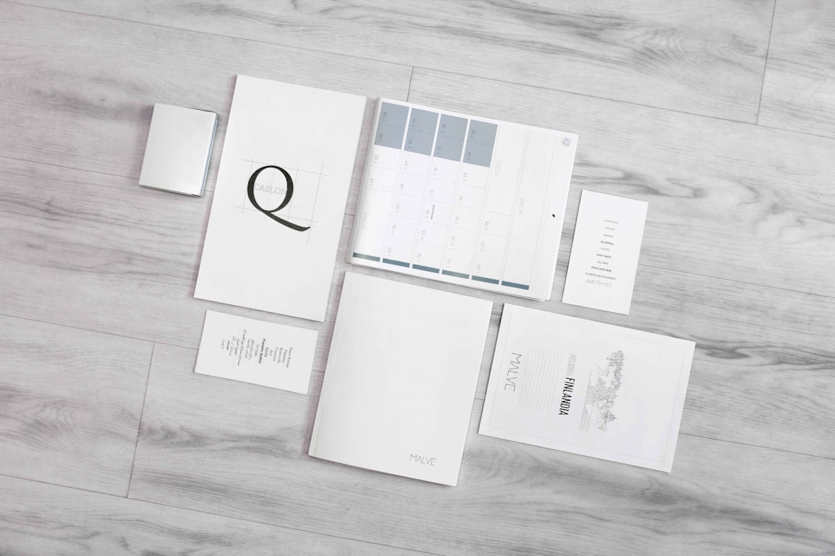 A brand collateral system laid out: brochures, cards and a colour chart