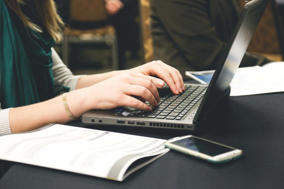 A person typing on a laptop