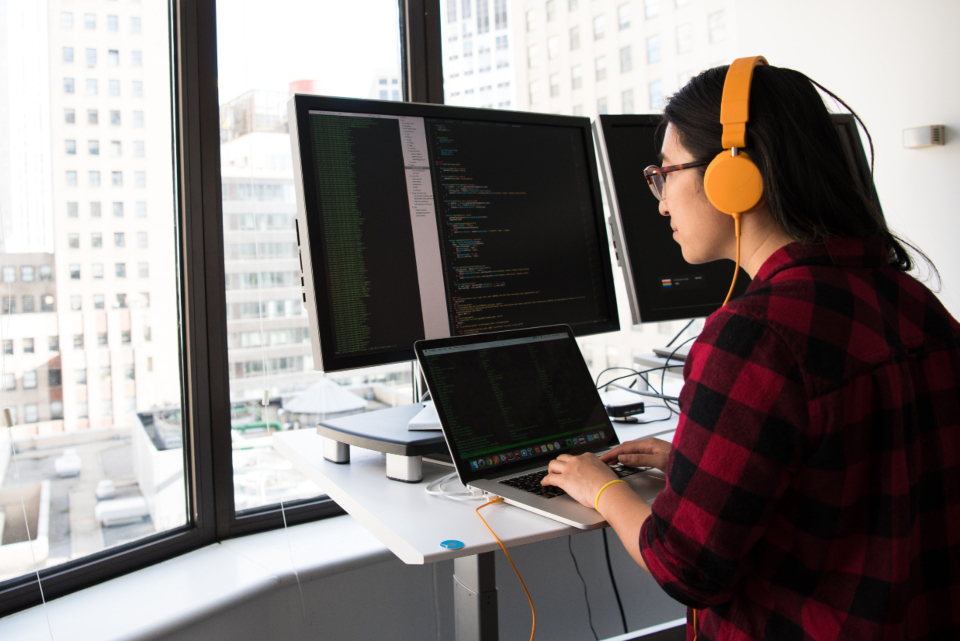 Code shown across multiple monitors