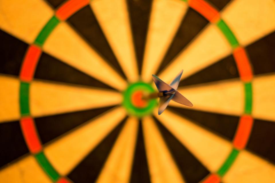 Darts in the bullseye of a dartboard