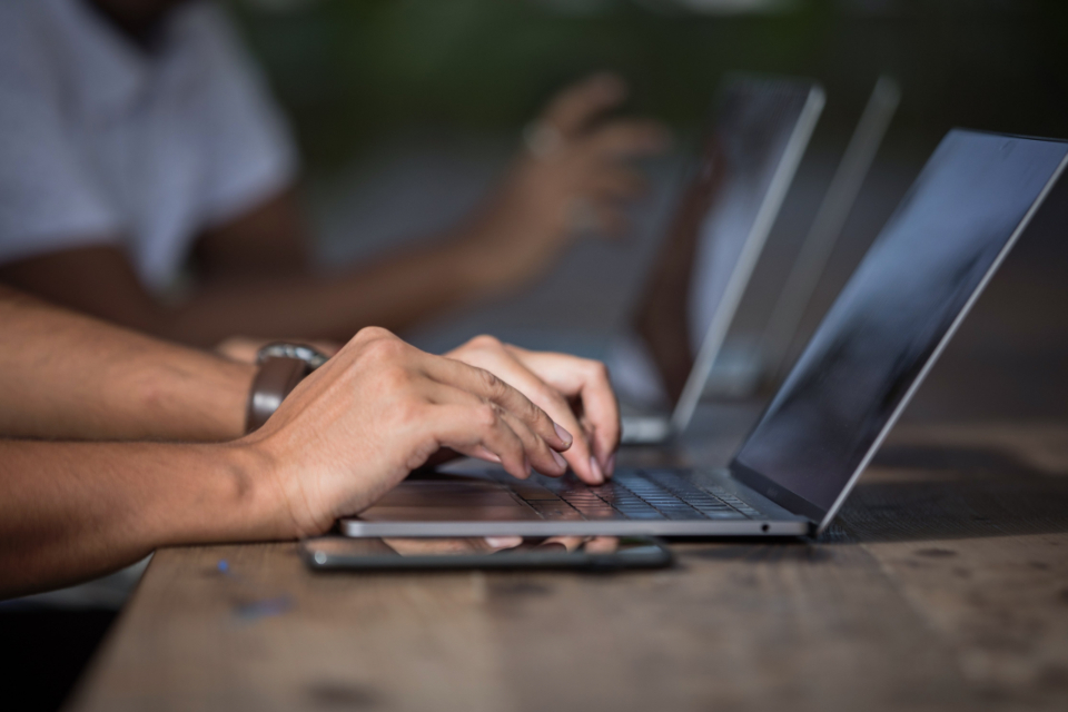 People collaborating at a laptop