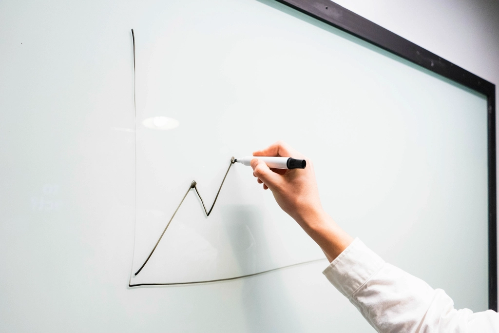 A hand drawing a diagram with a pen
