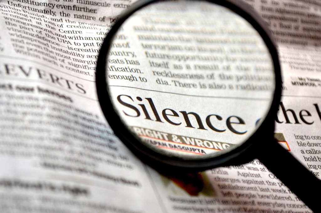A magnifying glass held over a page of newspaper text
