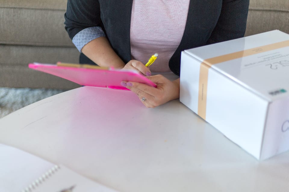 A hand holding a clipboard