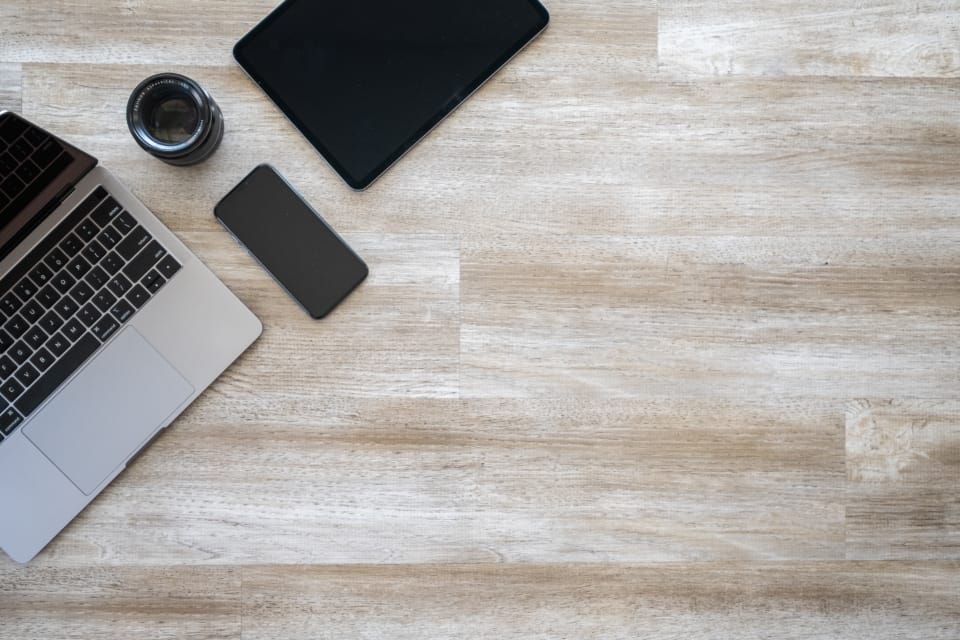 A workspace with a laptop and devices on a desk