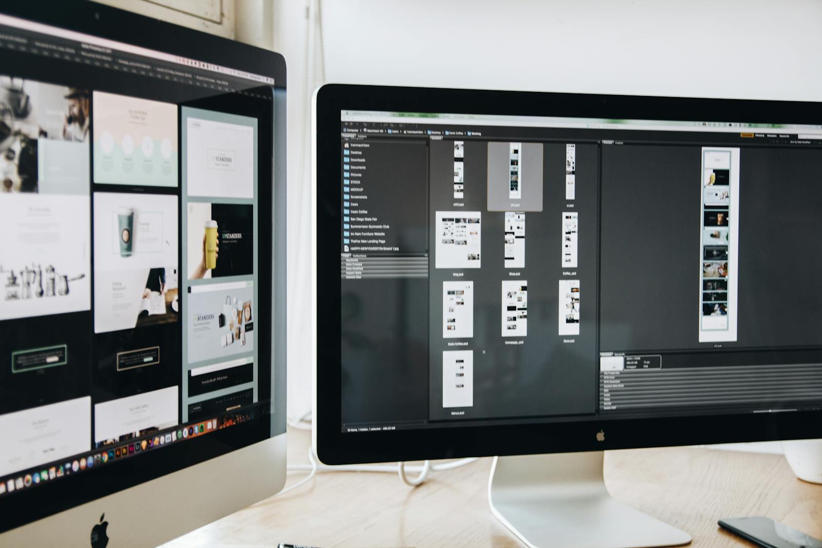 Designer's desk with two monitors showing web mockups in Photoshop and Bridge