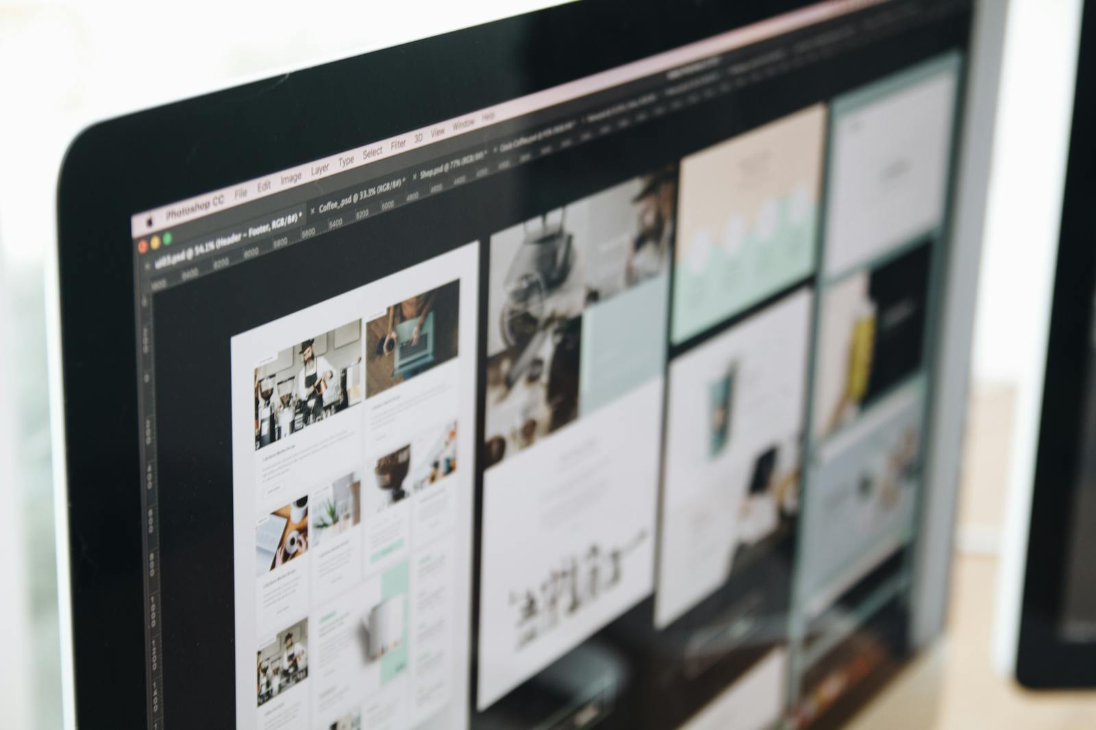 MacBook displaying a coffee-themed website layout open in Photoshop