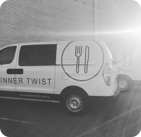 Dinner Twist branded delivery vans in a lot